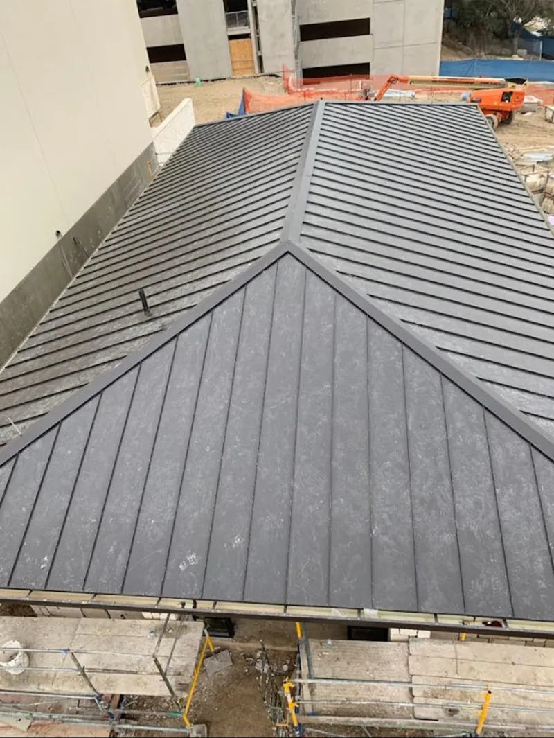 Commercial metal roof construction with crane equipment in Globe