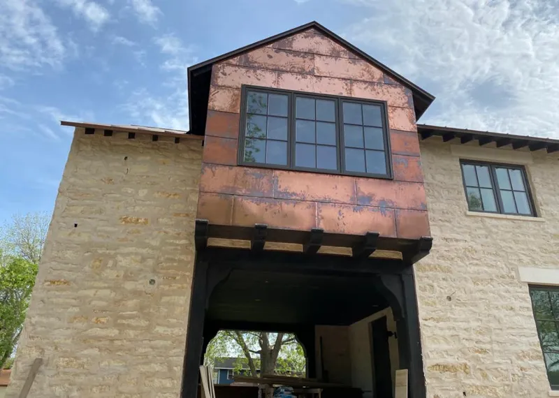 Copper metal panel facade on a stone building for Roof Repair in Globe