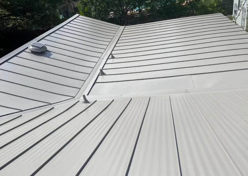 Solar attic fan installed on a metal roof for Roof Ventilation in Globe